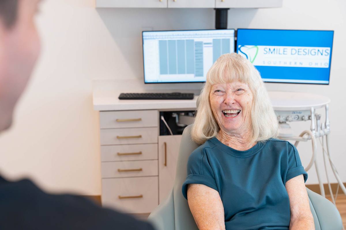 Patient laughing in the treatment chair during a visit
