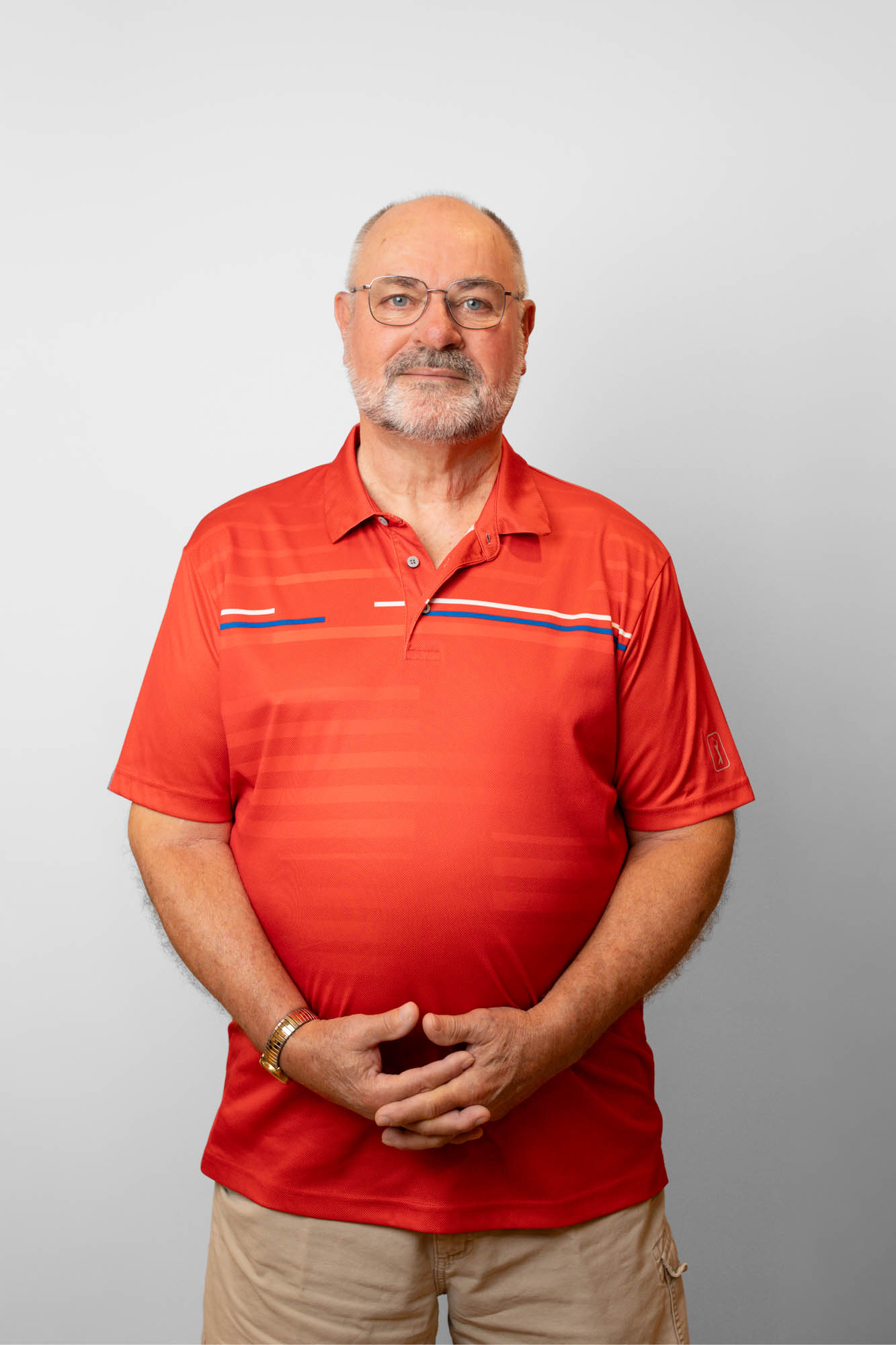 Smiling older male patient in a red shirt