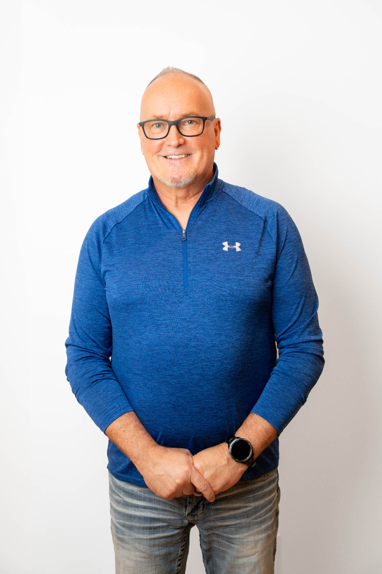 Smiling older male patient in a blue pullover