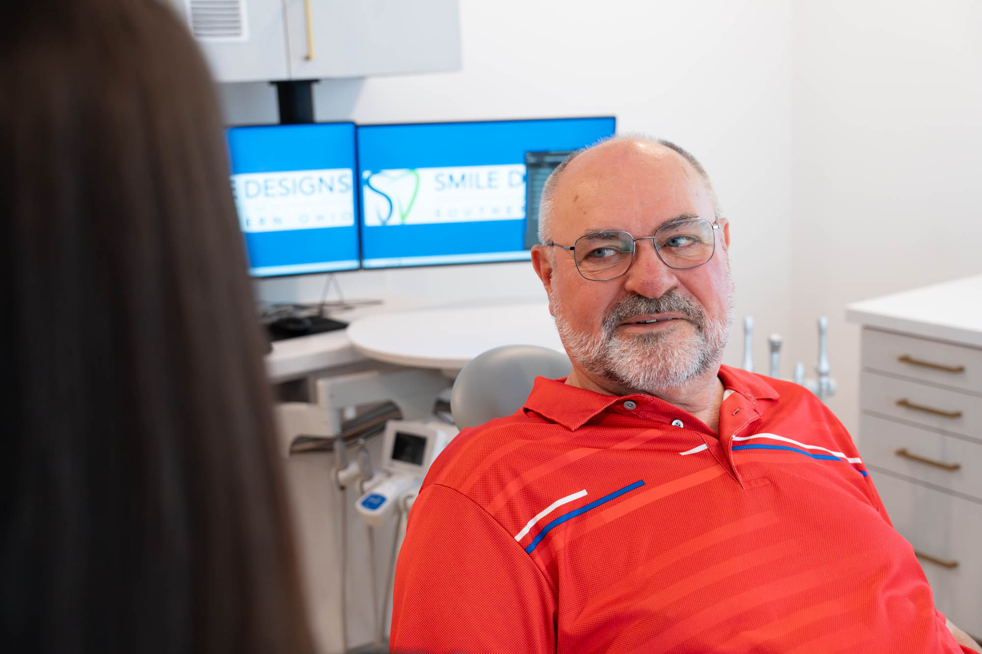 Smiling patient seated in the treatment chair