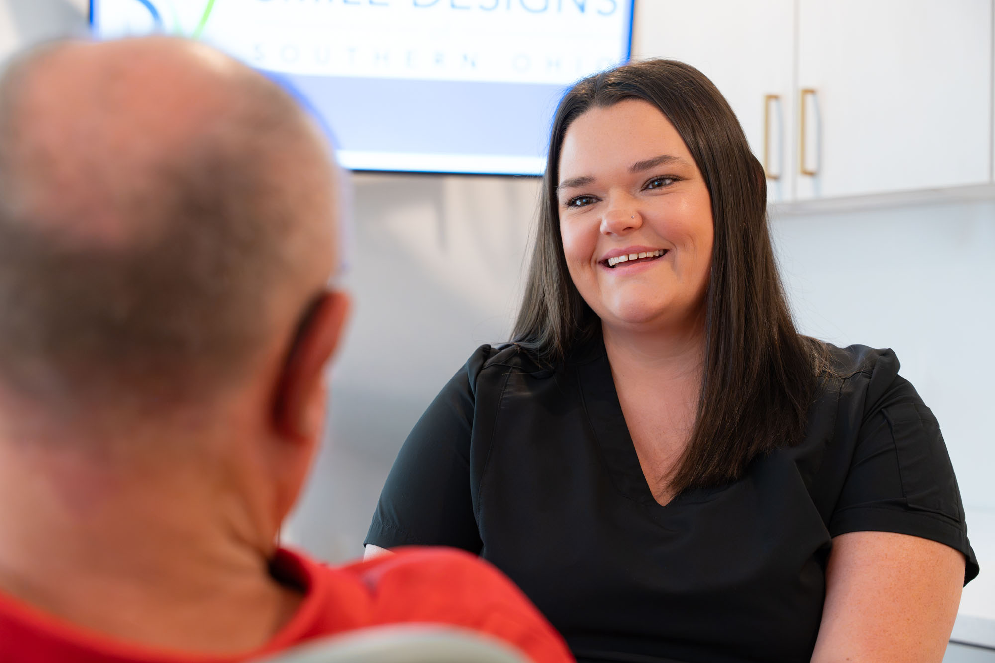 Smiling team member talking with a patient