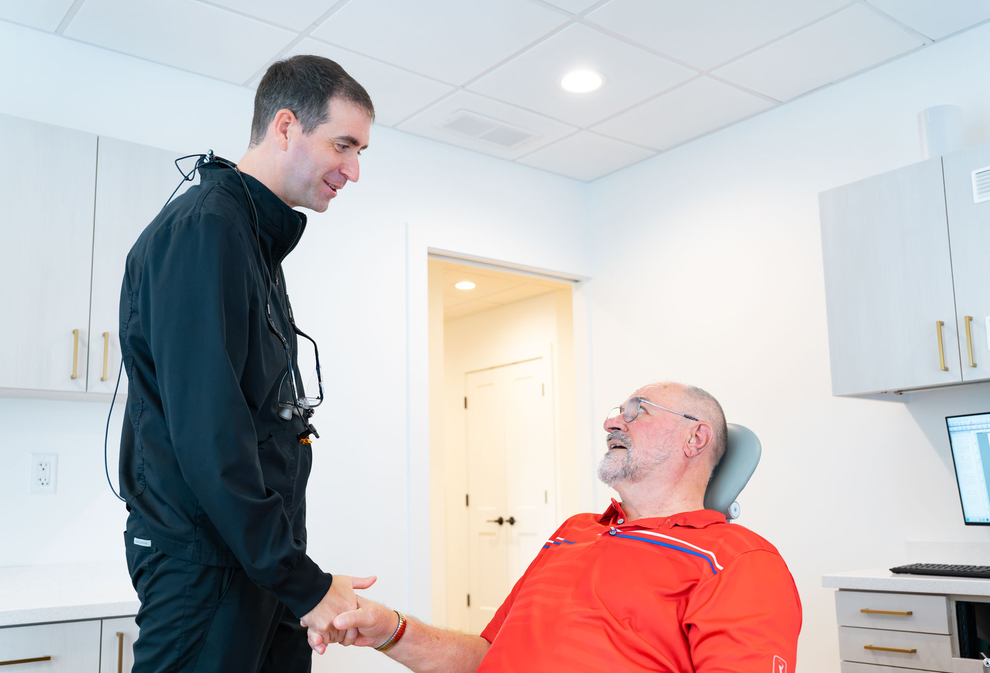 Dr. Ben McDonald greeting a patient in the treatment chair