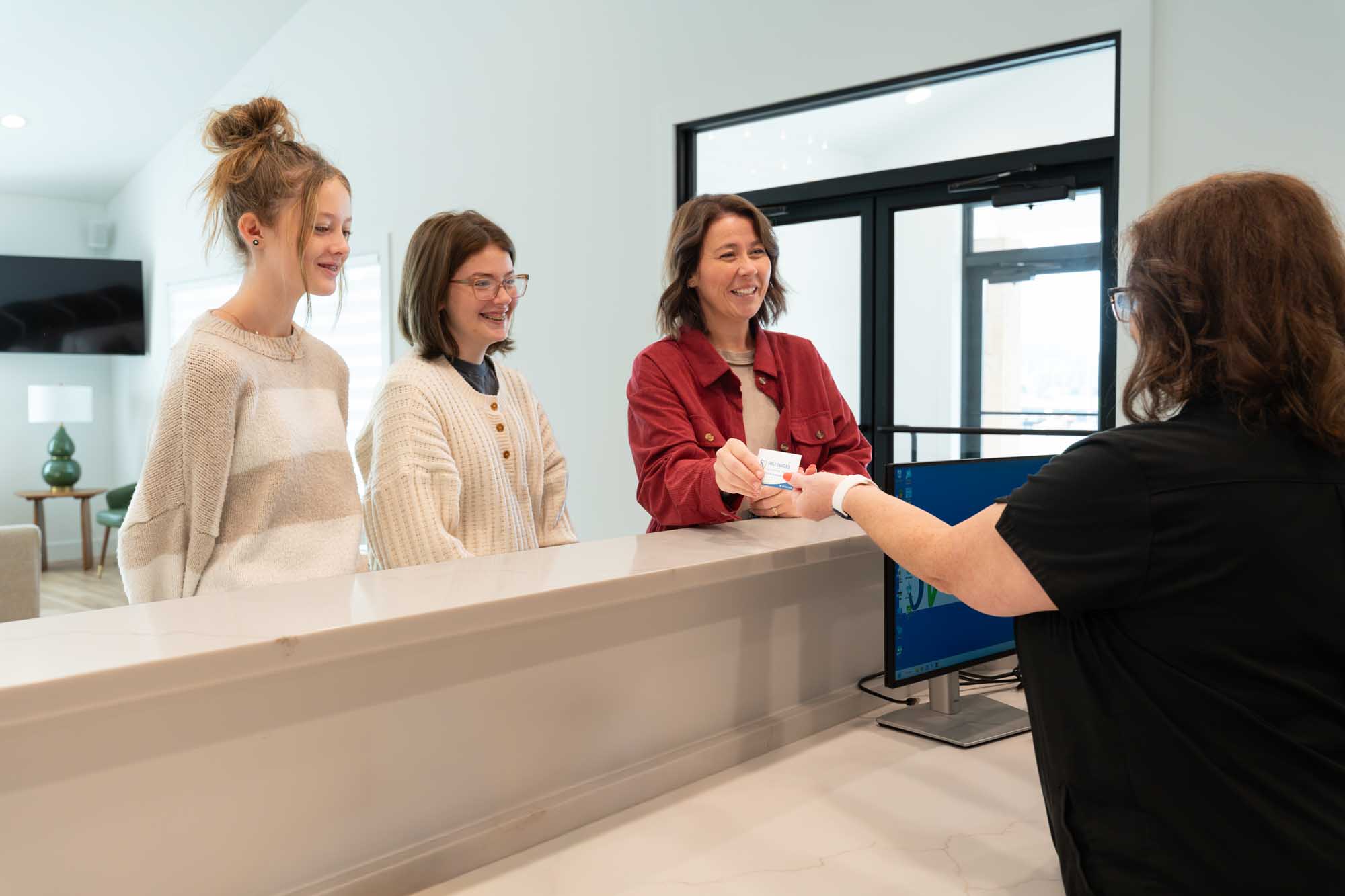 Family checking in at the reception desk