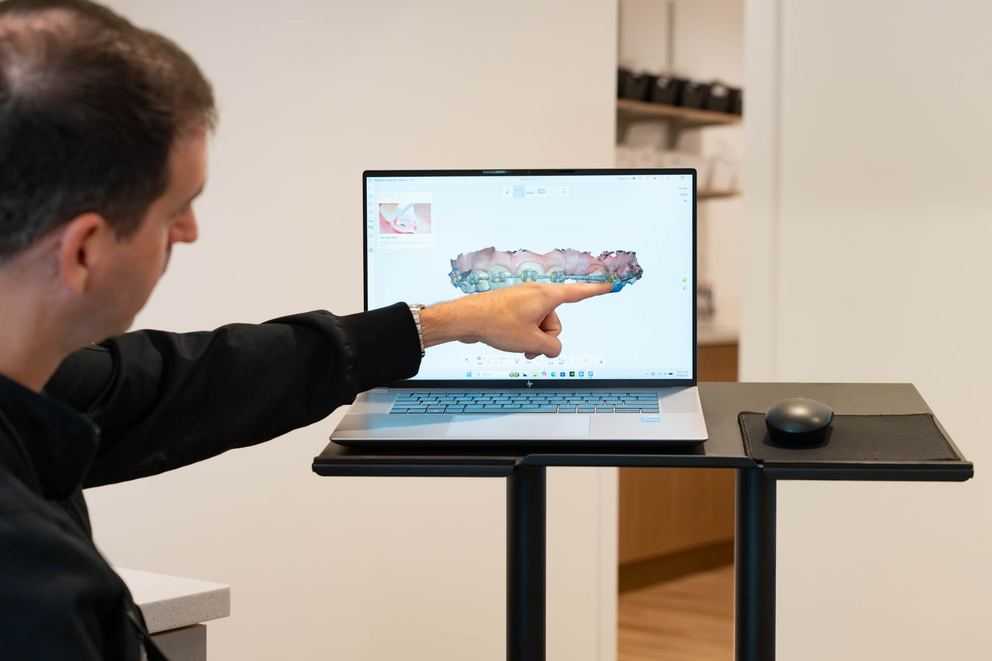 Dr. Ben McDonald pointing to a 3D scan of a patient's teeth