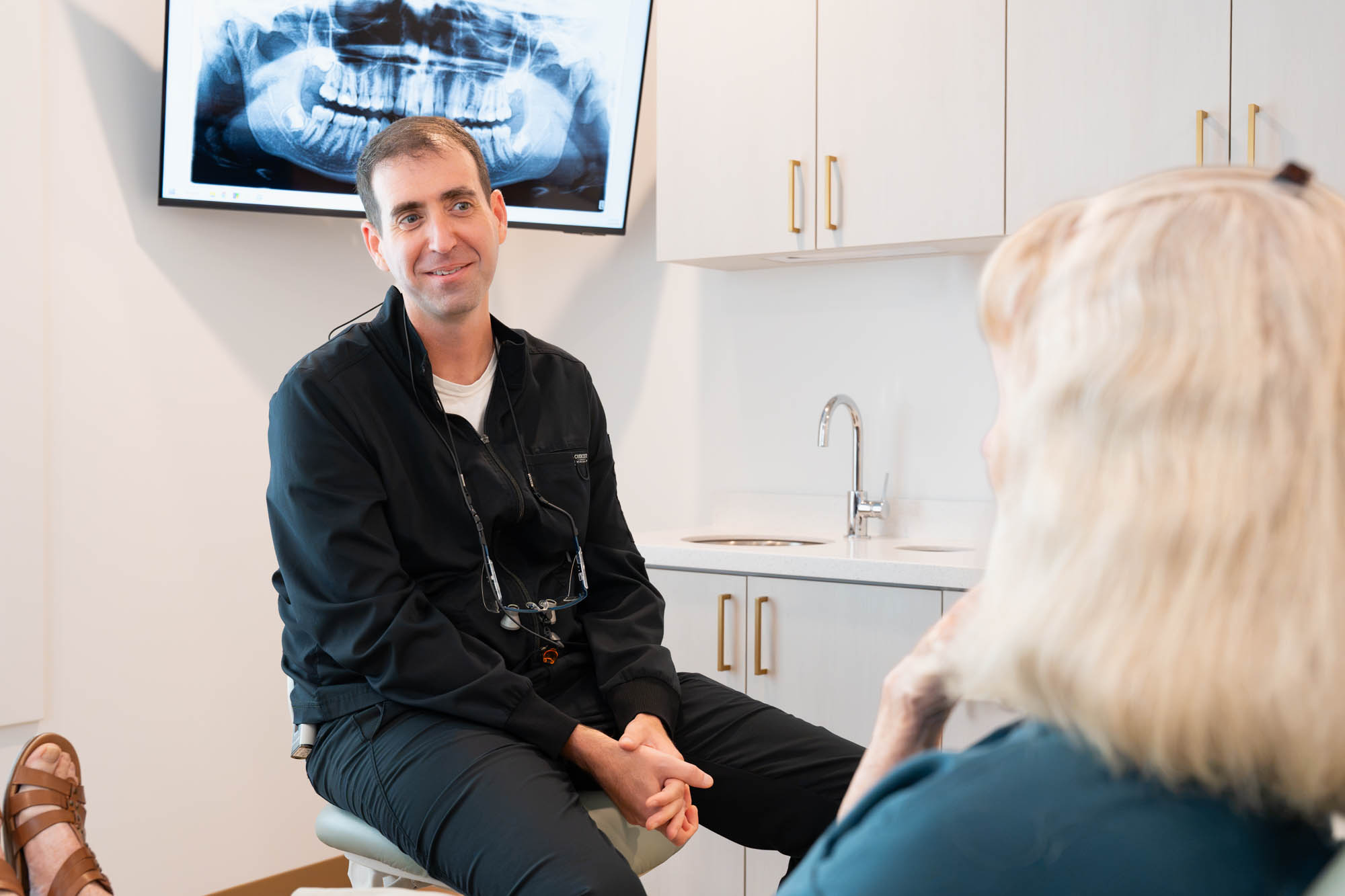 Dr. Ben McDonald talking with a patient in the treatment room