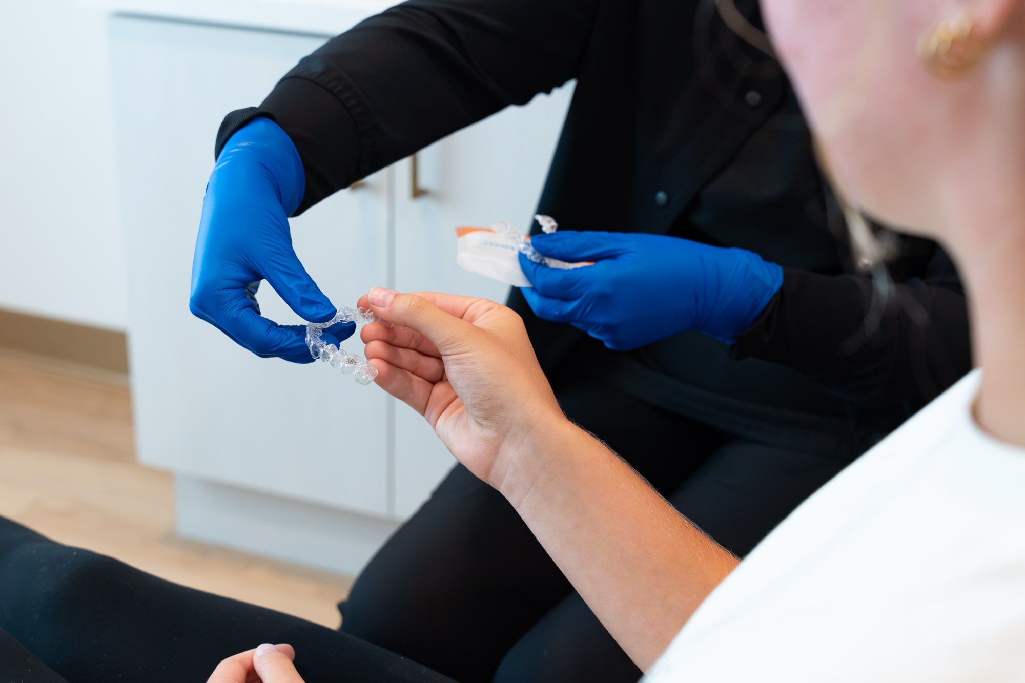 Patient receiving a new clear aligner tray