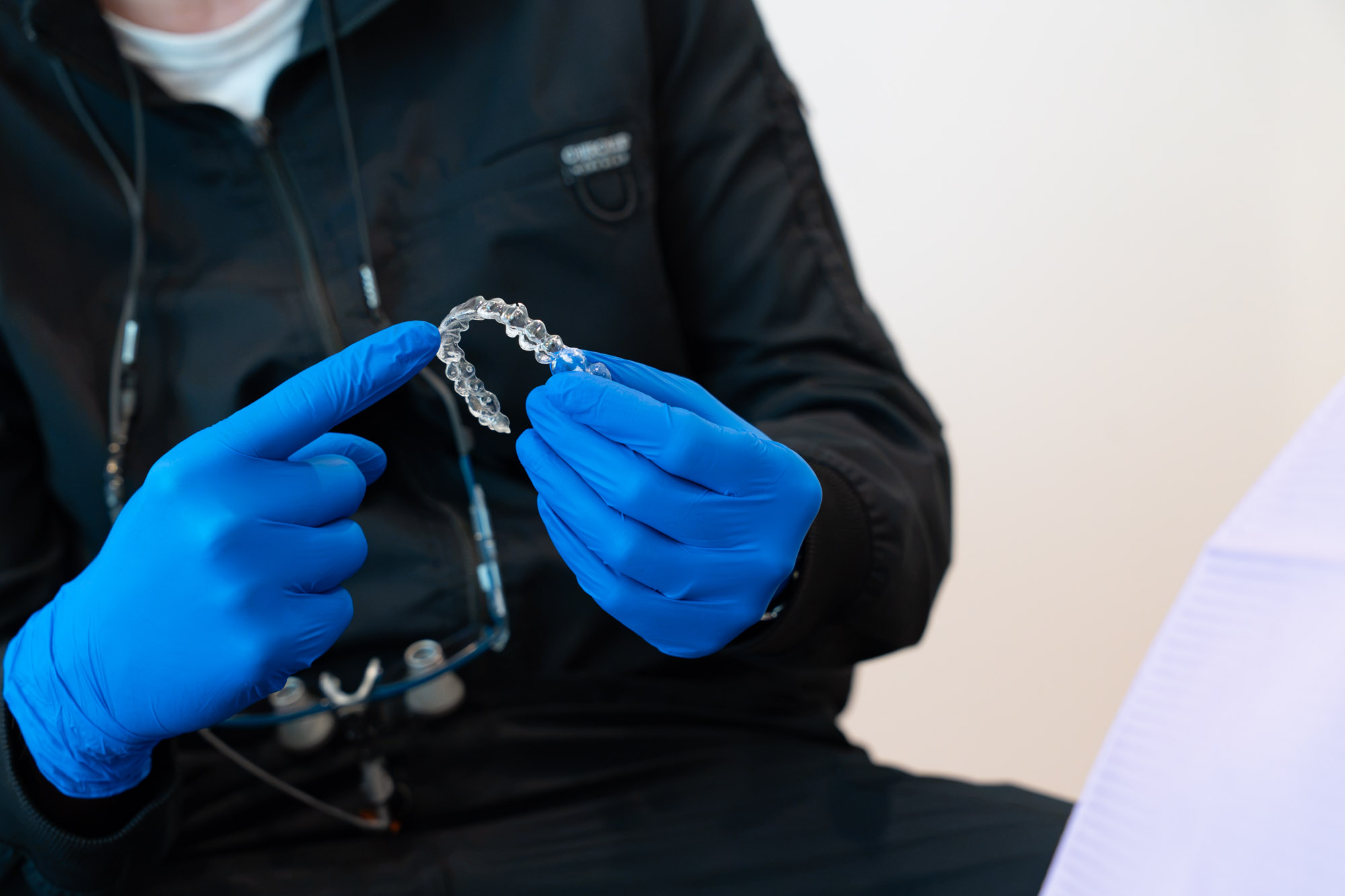 Close-up of Dr. McDonald holding a clear aligner tray