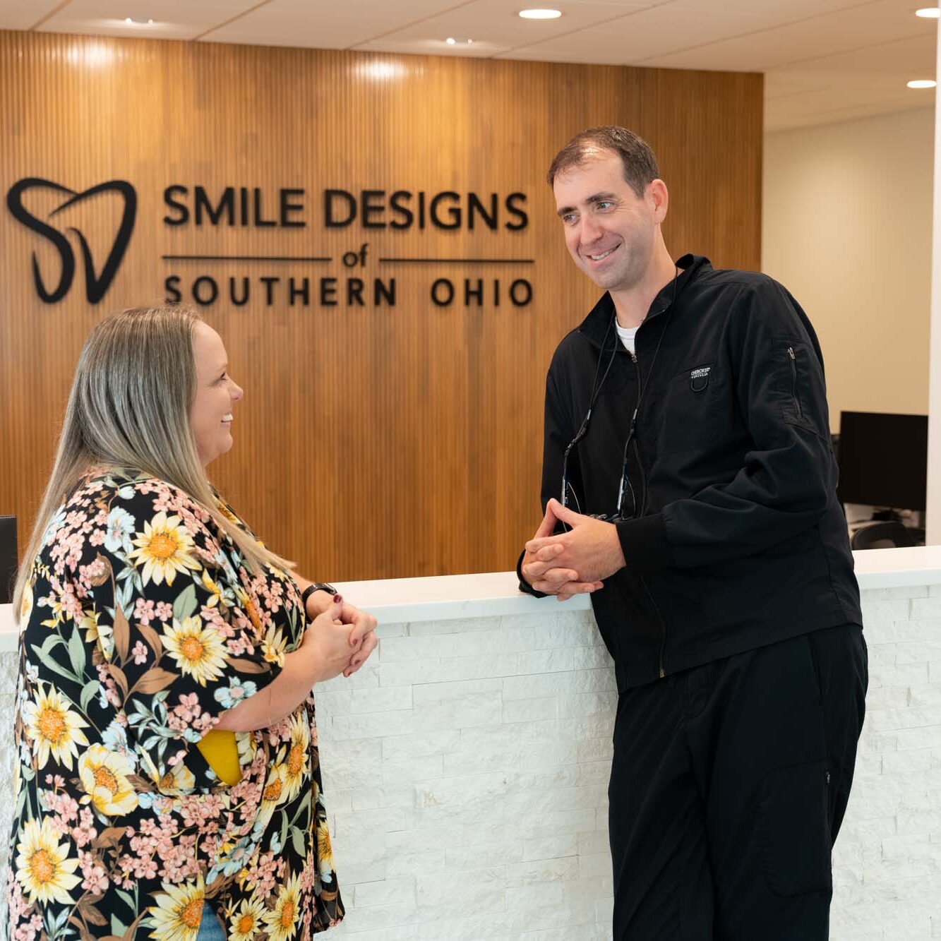 Dr. Ben McDonald talking with a patient in the reception area